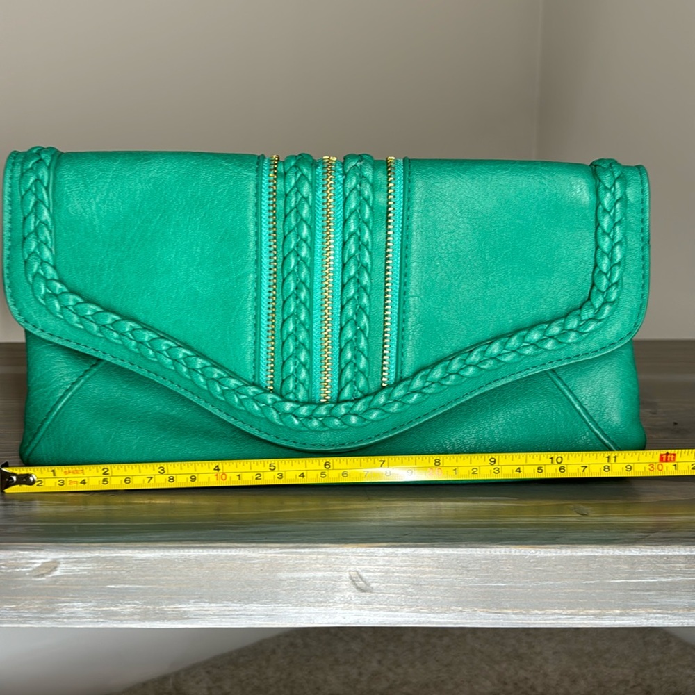 Green clutch with zipper and braided detail. Strap optional